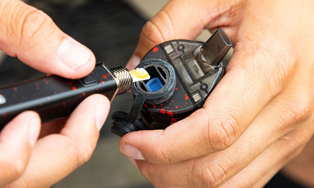 man loading the Wulf Growler using a hot knife tool