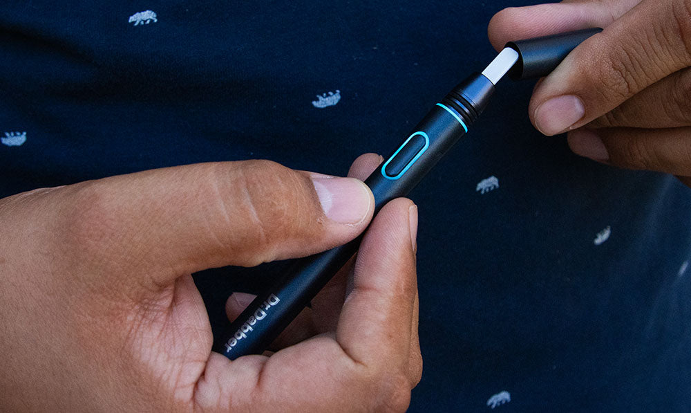 dr dabber hot knife with man holding both ends on lifestyle background