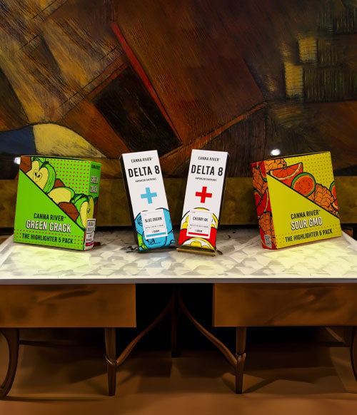 Canna river products on wooden table with wall art behind