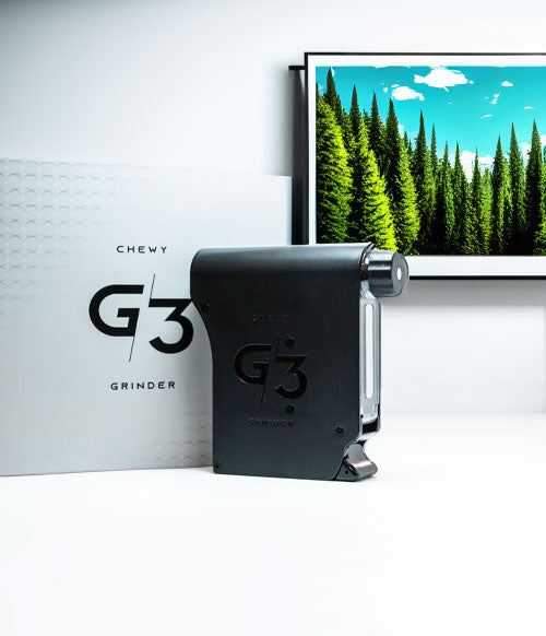 Chewy G3 Grinder standing in front of wall art