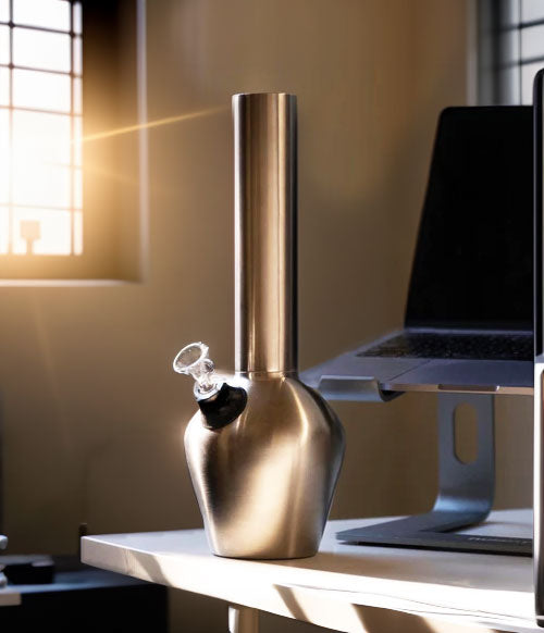 Chill pipe on work desk with computer and sunrays shining