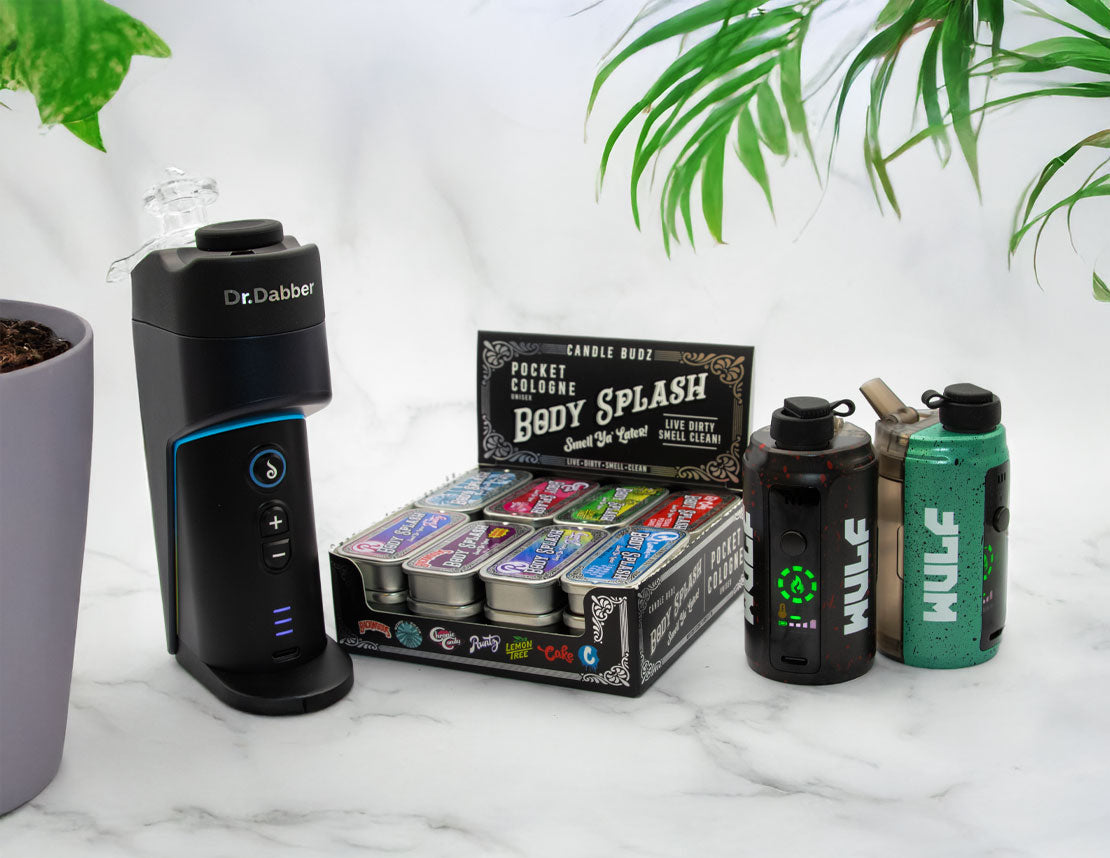 Dr. Dabber Switch GO with body splash products and Wulf Growlers on a marble surface.