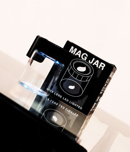 Mag Jar standing on reflective glass window with packaging nearby