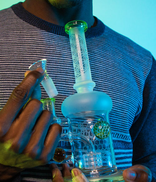 man holding waterpipe with blue lighting