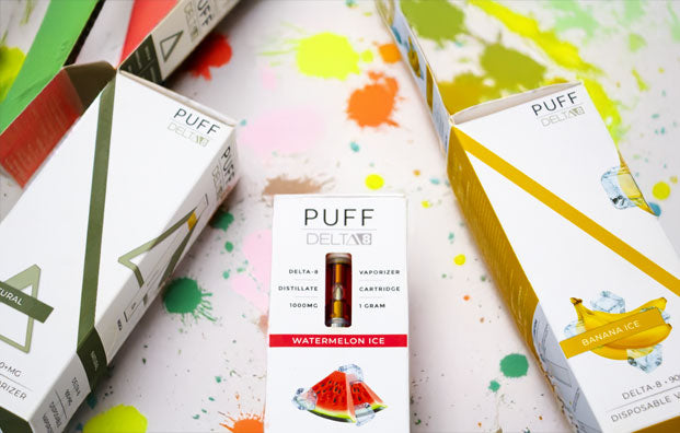 Puff Delta 8 lying on white surface with paint splatters