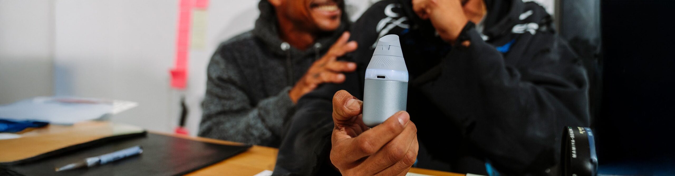 two men smiling using the Puffco Proxy Core