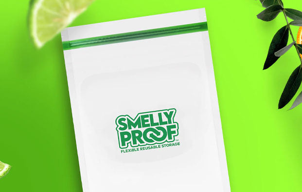 Smelly Proof bag resting on green background with limes and plants nearby