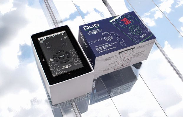 Stratus products resting on reflective glass surface with clouds above