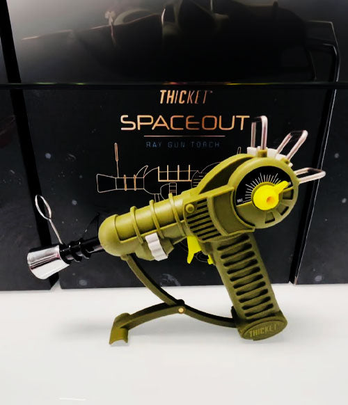 Thicket torch standing on white display in front of packaging