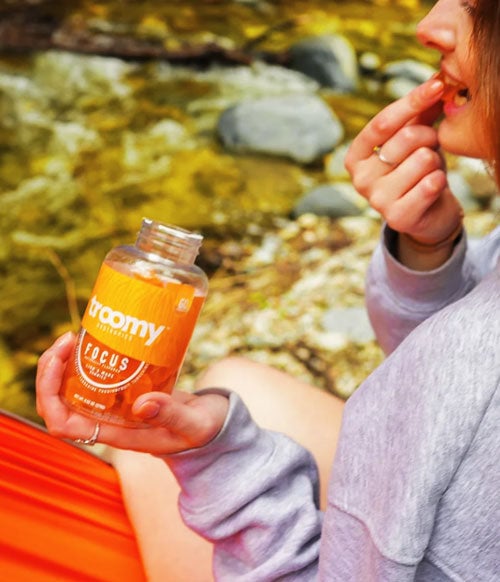 Troomy product held by a woman in a cot by the water