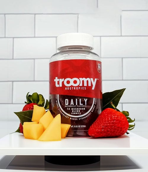 Troomy Product Standing On White Display With Fruits