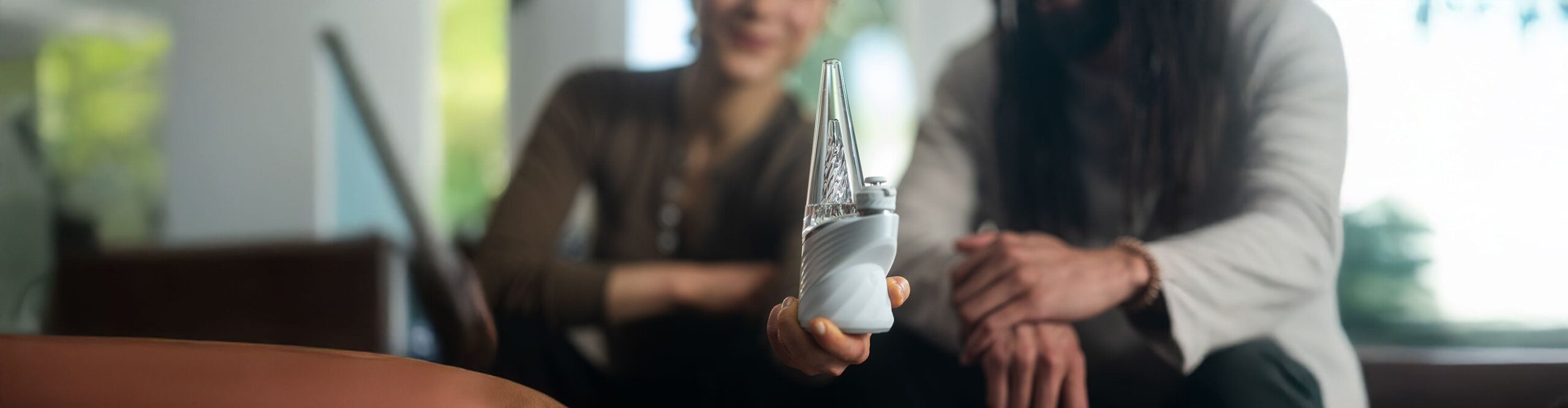 woman and man using the Puffco Peak Pro at home