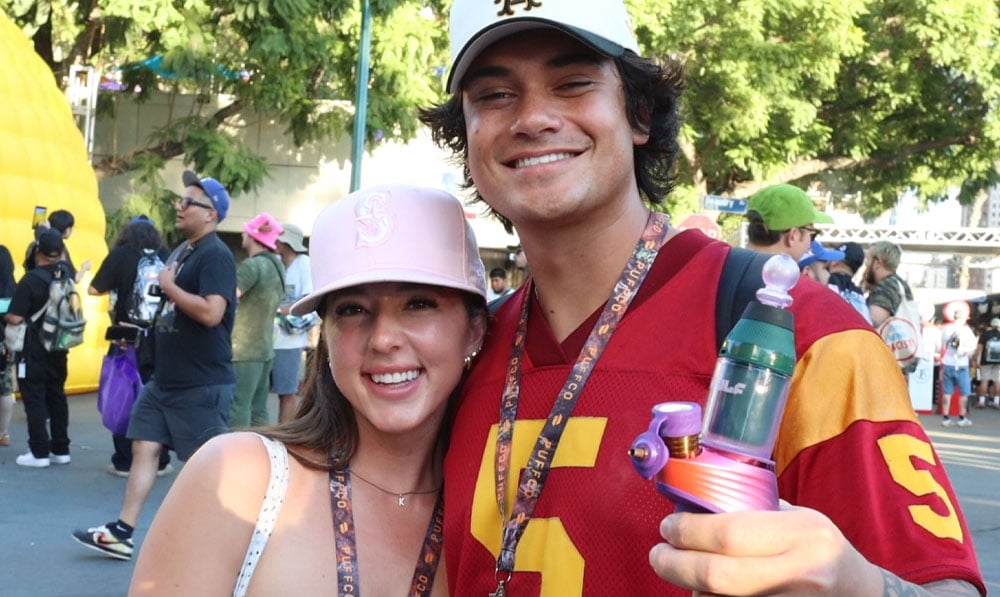 Social Media Influencer holding the Puffco Peak with Wulf Merge glass attachment at Puffcon